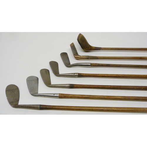 412 - Group of seven antique Scottish hickory-shafted and metal golf clubs to include a long iron, stamped... 