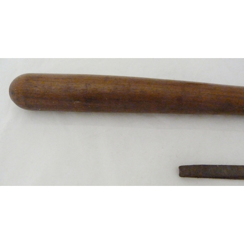 391 - Two late Victorian truncheons, in oak and walnut, one with leather strap, 39cm long.  (2)