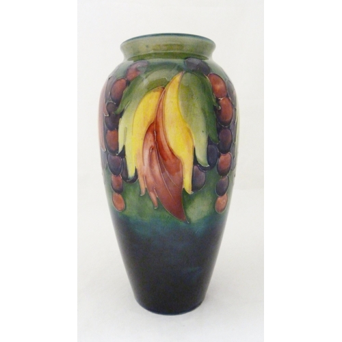 314 - William Moorcroft grape and leaf design tube-lined oviform vase, glazed in green and blue, stamped t... 