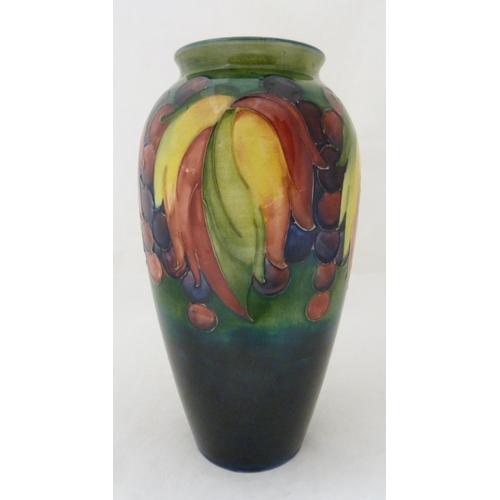 314 - William Moorcroft grape and leaf design tube-lined oviform vase, glazed in green and blue, stamped t... 