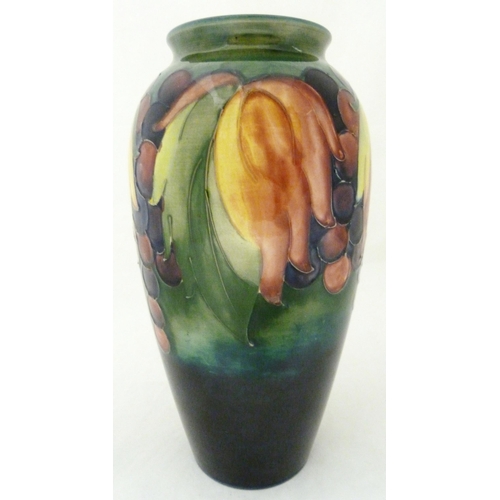 314 - William Moorcroft grape and leaf design tube-lined oviform vase, glazed in green and blue, stamped t... 