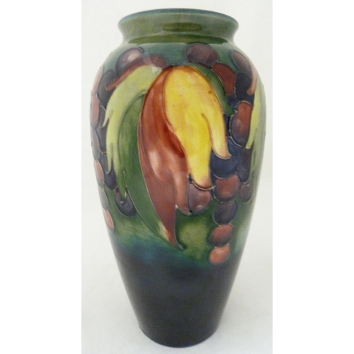 314 - William Moorcroft grape and leaf design tube-lined oviform vase, glazed in green and blue, stamped t... 