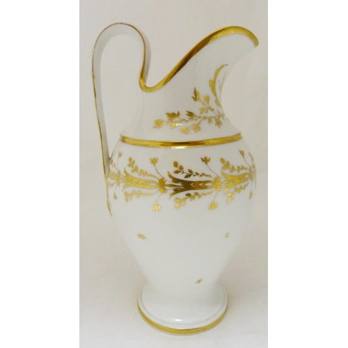 316 - Paris Porcelain ewer, c. 1790, of helmet form decorated with gilded foliage and borders on a white g... 