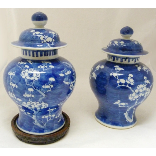 359 - Pair of Chinese blue and white baluster vases and covers, late Qing dynasty, decorated with flowerin... 