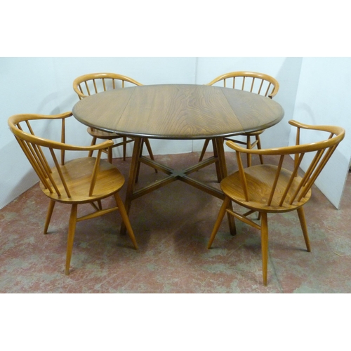 536 - Set of four mid-century Ercol elm and beech 'Cowhorn' chairs with stick backs, stamped to the unders... 