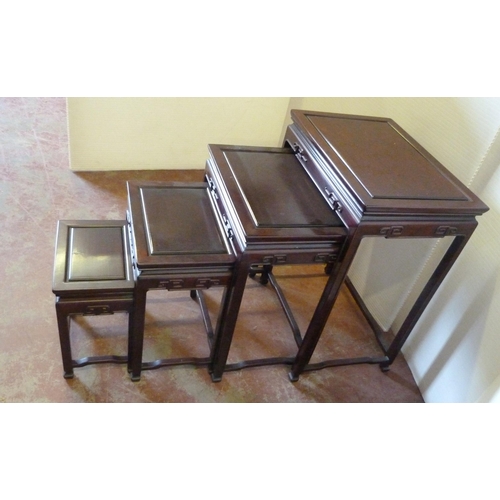 541 - Chinese-style quartetto nest of four graduated hardwood tables of reddish patina, the largest 66cm h... 