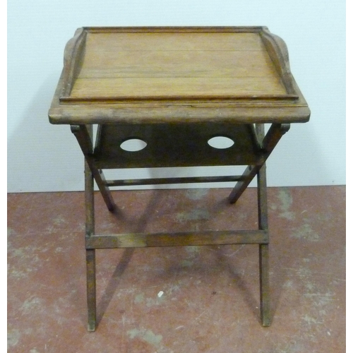 545 - Oak butler's table with fitted tray top above a shelf with four apertures, on folding supports, 76cm... 