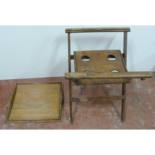 545 - Oak butler's table with fitted tray top above a shelf with four apertures, on folding supports, 76cm... 