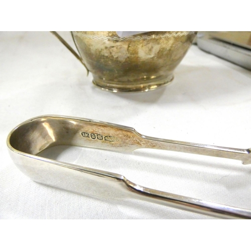 272 - Silver cream jug and a set of silver tongs (164g.)