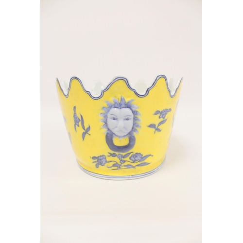 227 - Chinese style Monteith bowl on a yellow ground with blue foliage, and faux lion mask handles to each... 