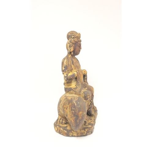 229 - Antique Chinese carved and painted wooden figure of Guanyin seated on an elephant, traces of gilt pa... 