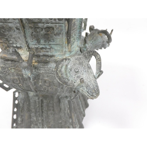 232 - Chinese bronze ritual wine vessel of square form, with rams heads to each corner. Height 20cm 