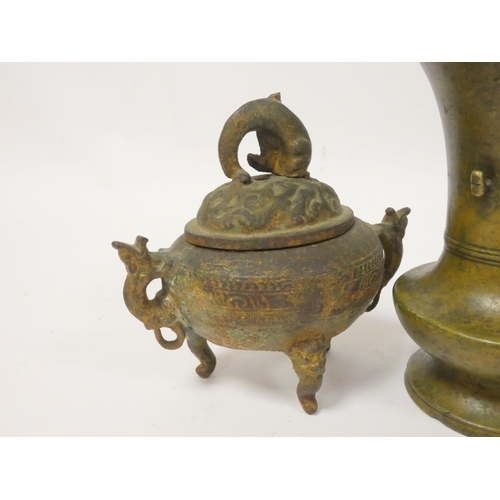 246 - Bronze pouring vessel with seated deity, Chinese bronze vase with floral panels, a Chinese trumpet s... 