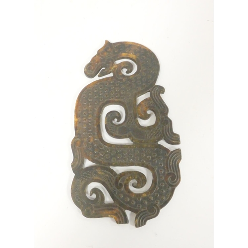 247 - A Chinese brown jade zoomorphic plaque of archaic form depicting a dragon. Length 29cm. 