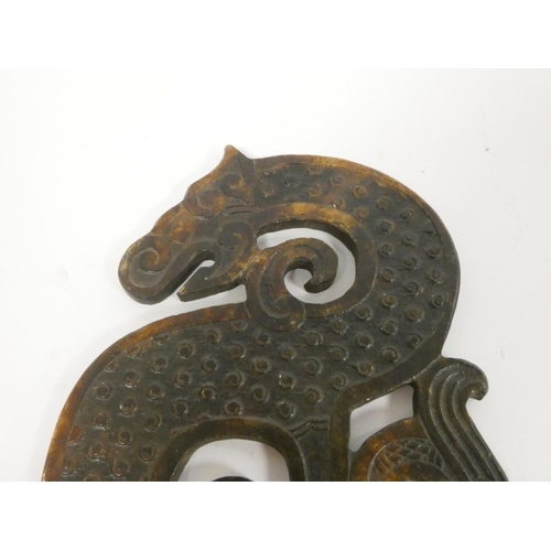 247 - A Chinese brown jade zoomorphic plaque of archaic form depicting a dragon. Length 29cm. 