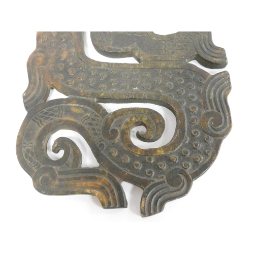 247 - A Chinese brown jade zoomorphic plaque of archaic form depicting a dragon. Length 29cm. 