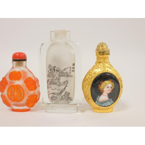 252 - Three various snuff bottles to include overlaid Chinese, another with red glass overlay depicting lo... 