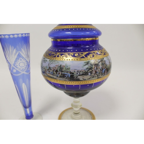 298 - Continental blue and gilt Bohemian style glass cup and cover and a blue flash trumpet vase. (2)