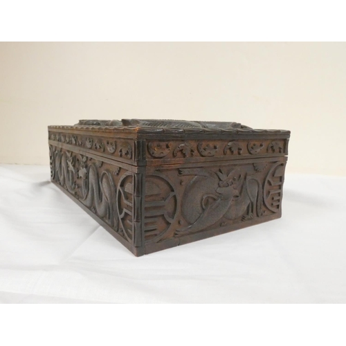 257 - 19th century Chinese camphor wood box the lid bearing a family crest flanked by two five clawed drag... 