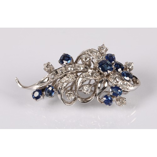 52A - Ladies 14ct whit gold Diamond & Sapphire cluster brooch, set with nine oval cut Sapphires and tw... 