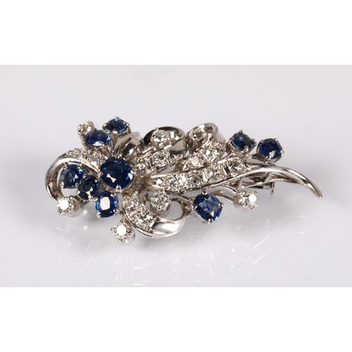 52A - Ladies 14ct whit gold Diamond & Sapphire cluster brooch, set with nine oval cut Sapphires and tw... 