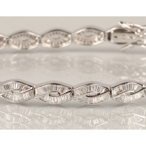 53A - Ladies 18ct white gold Diamond bracelet, consisting of twenty two links set with baguette cut diamon... 