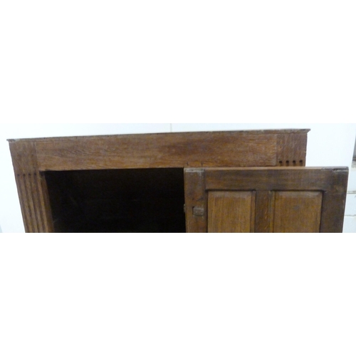 551 - Antique oak lectern with sloped ledge to the front above six panels, flanked by reeded columns, with... 