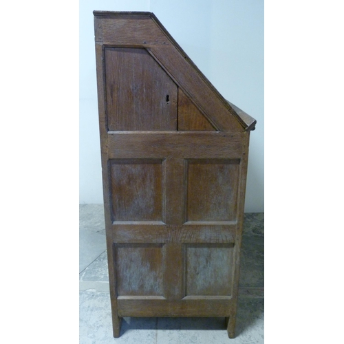 551 - Antique oak lectern with sloped ledge to the front above six panels, flanked by reeded columns, with... 