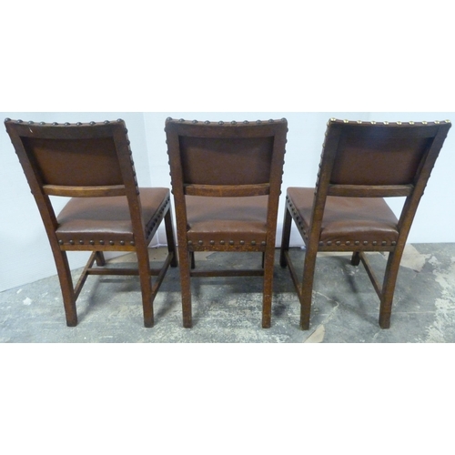 552 - Near-set of thirty oak English dining chairs, c. 1950s, with studded upholstery, stamped to the unde... 