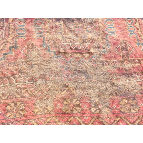 388 - Large 19th Century Persian Bokhara, red and blue rug L320cm x W227cm.