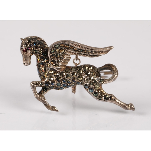 127 - Silver pegasus brooch hallmarked Birmingham 1964, set with marcasite and a red gemstone eye, 9.8, wi... 