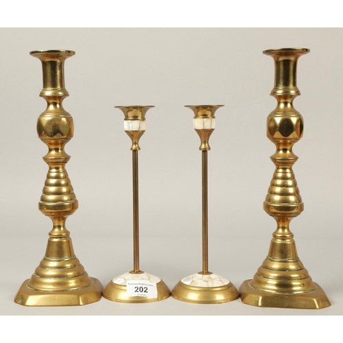 202 - Two pairs brass candlesticks