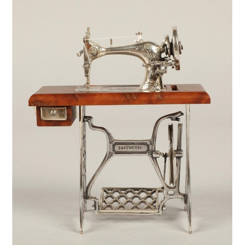 208 - Miniature Sacchetti sewing machine with parts in silver and white metal 