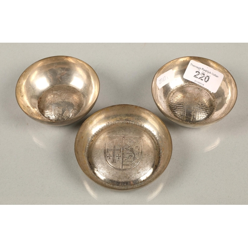 220 - Three white metal bowls with heraldic designs, 126g