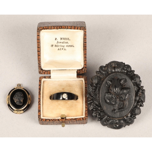 51 - Carved jet brooch, jet ring set with a single gem, and a black enamel/glass brass cameo pendant (3)