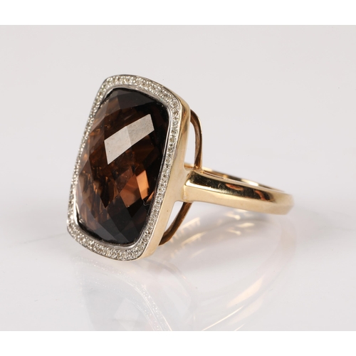 87 - 9ct yellow gold ring set with a large faceted smoky quartz gem surrounded by a halo of diamonds, rin... 