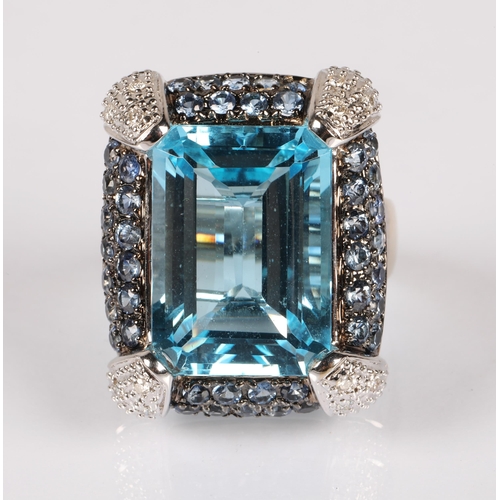 90 - 18K white gold cocktail ring set with a large pale blue gem, surrounded by smaller blue gems and dia... 