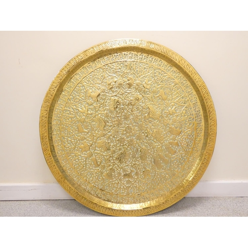 283 - Antique Burmese large circular brass tray bearing all over repousse floral decoration with central b... 