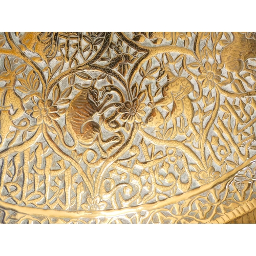 283 - Antique Burmese large circular brass tray bearing all over repousse floral decoration with central b... 