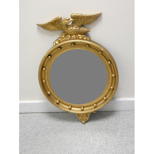 397 - 19th century circular wall mirror in gilt gesso frame bordered with orbs, and having eagle pediment.... 