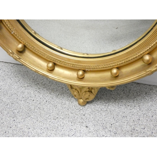 397 - 19th century circular wall mirror in gilt gesso frame bordered with orbs, and having eagle pediment.... 