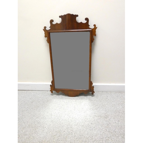 399 - 19th century mahogany fret framed mirror of rectangular form having scrolled pediment. 46cm x 79cm.