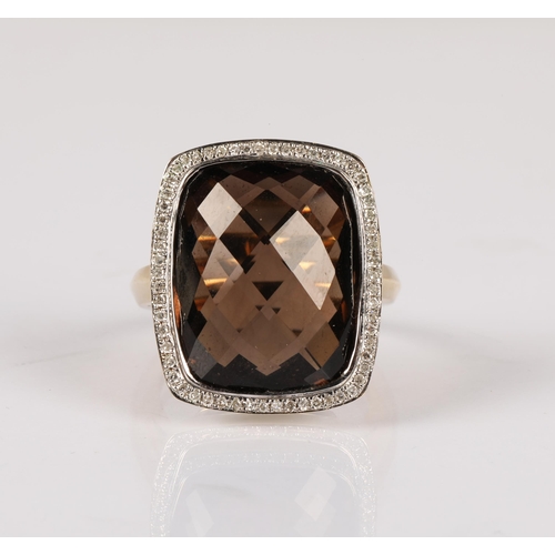 87 - 9ct yellow gold ring set with a large faceted smoky quartz gem surrounded by a halo of diamonds, rin... 