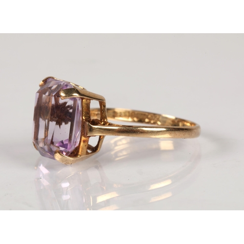 94 - 9ct gold dress ring set with a purple gemstone, 3g