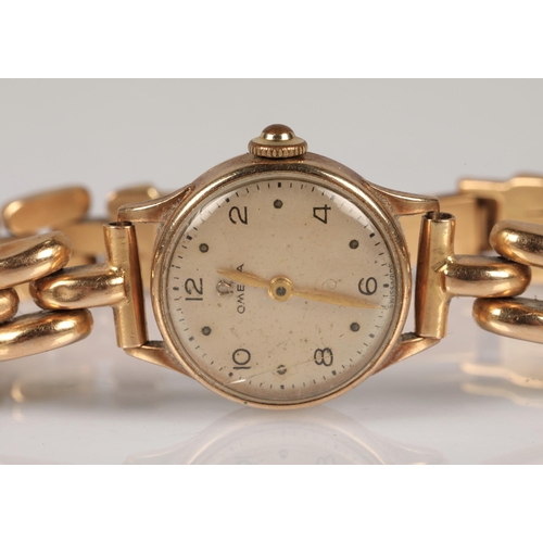 104 - 9ct gold ladies Omega wristwatch,  on a n 18ct gold strap stamped 750, gross weight 24.2g