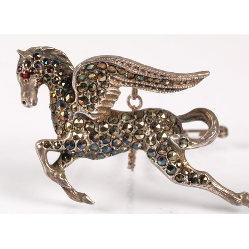 127 - Silver pegasus brooch hallmarked Birmingham 1964, set with marcasite and a red gemstone eye, 9.8, wi... 