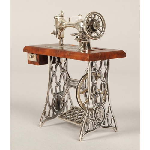 208 - Miniature Sacchetti sewing machine with parts in silver and white metal 