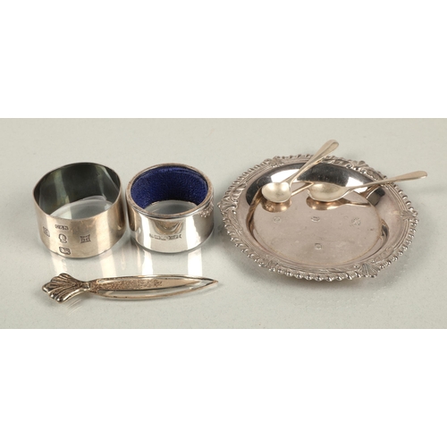 212 - Hallmarked silver to include dish marked Sheffield 1977, two salt spoons, two napkin rings, and a bo... 