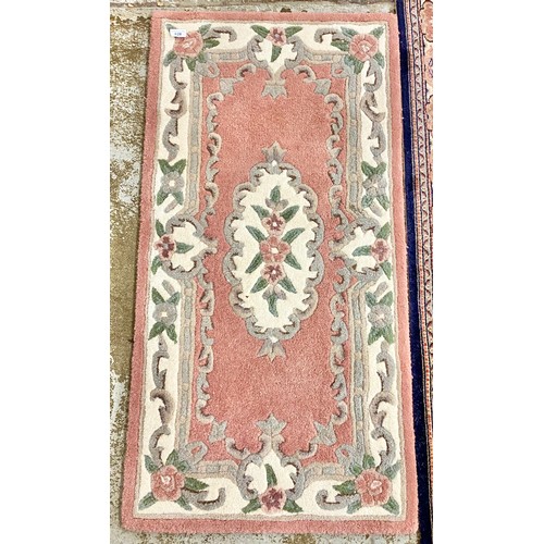 628 - Two floral floor rugs