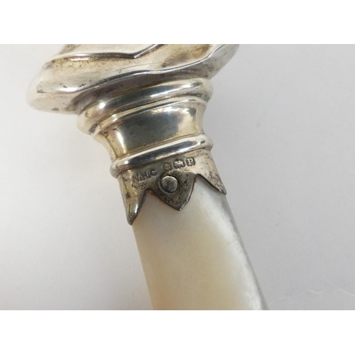 104 - Pearl ring in 9ct gold, a silver cross and chain and a silver rattle